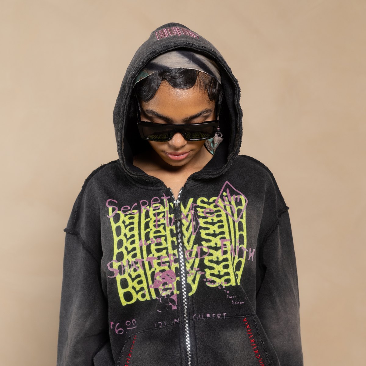 Model in the black Barelysain graffiti-print zip hoodie